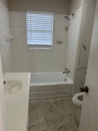 a bathroom with a tub a sink and a shower