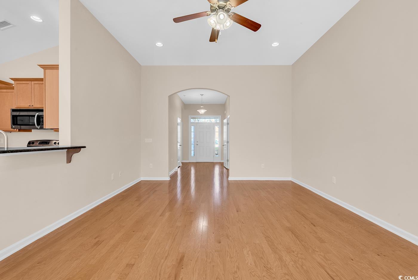 1612 Fairforest Court Conway, SC 29526 - Photo 17 of 40 Unfurnished living room featuring light wood-style floors, arched walkways, a ceiling fan, and recessed lighting