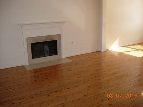 a view of an empty room with a fireplace
