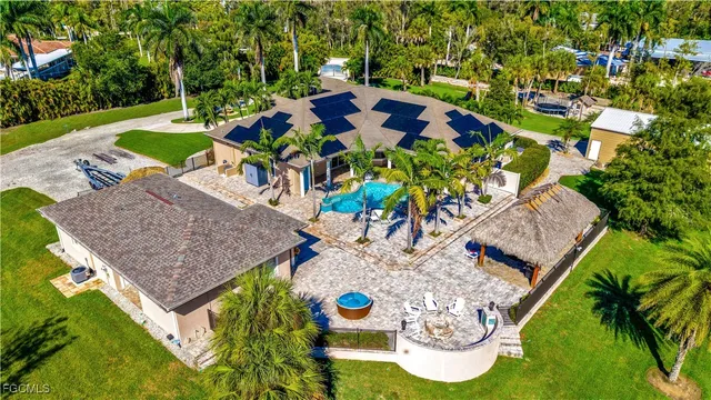 an aerial view of house with yard swimming pool and outdoor seating