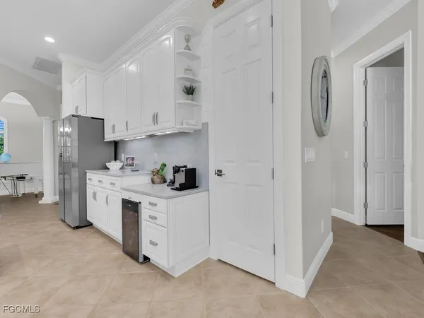 a kitchen with white cabinets and white appliances