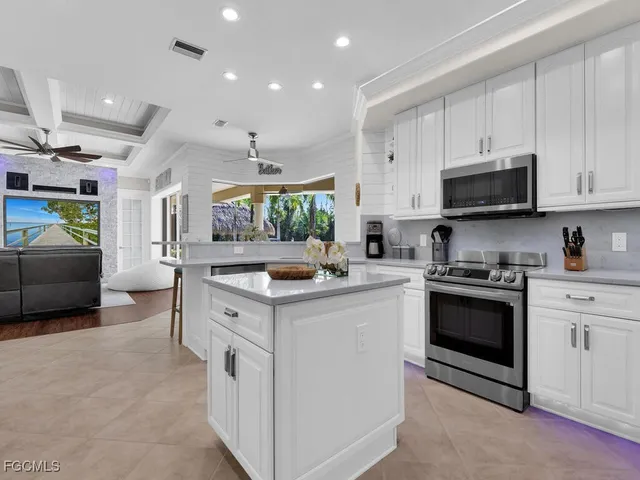a kitchen with stainless steel appliances granite countertop a stove and a sink