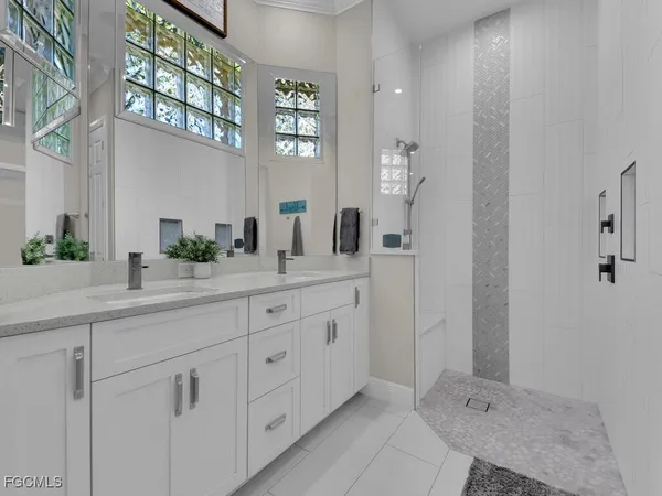 a spacious bathroom with double sink and a mirror