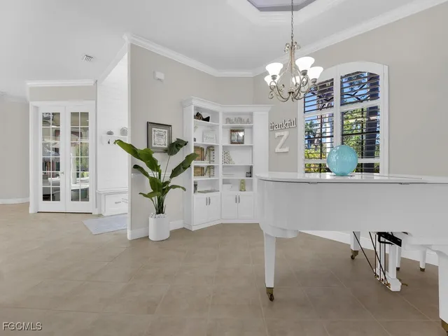 a view of living room filled with furniture and a chandelier