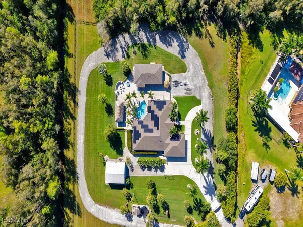 an aerial view of residential house with outdoor space and swimming pool
