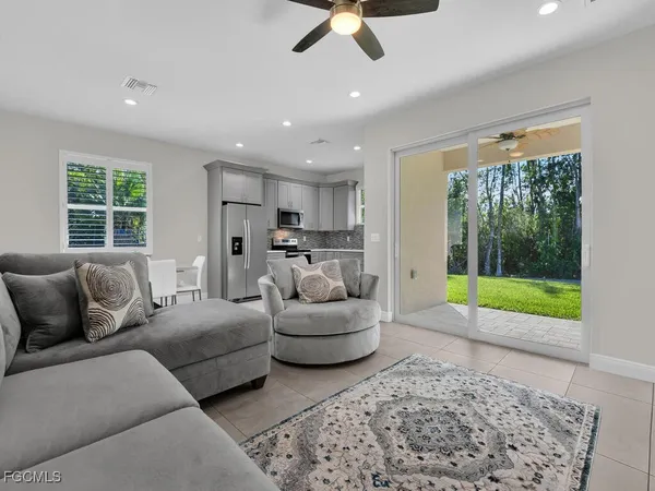a living room with furniture and a floor to ceiling window