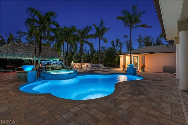 a view of a swimming pool with a table and chairs