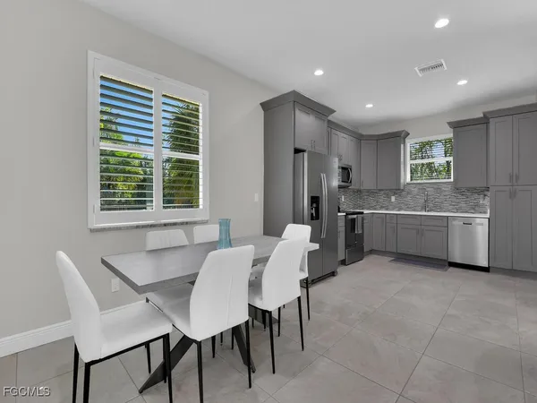 a living room with stainless steel appliances kitchen island granite countertop furniture and a kitchen view