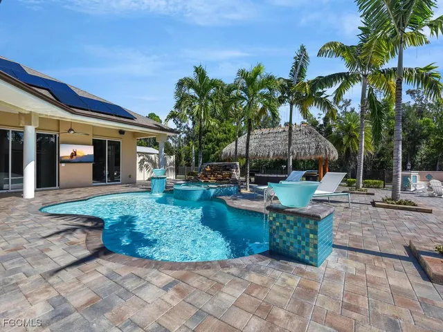 a view of a house with backyard and sitting area