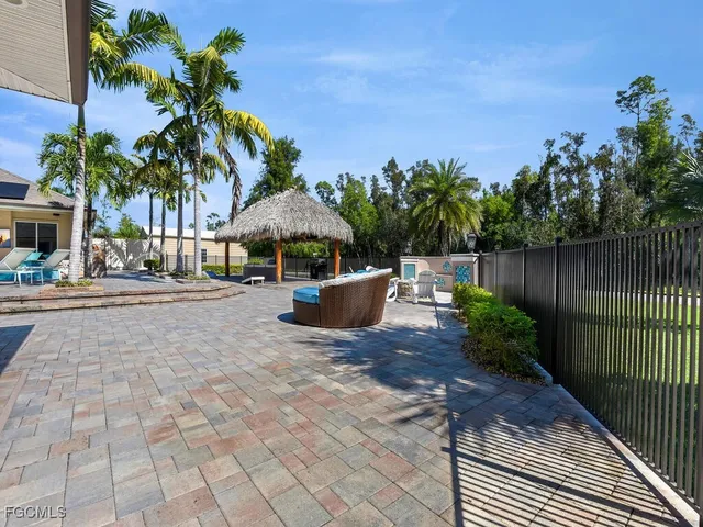 a view of a backyard with plants and outdoor seating