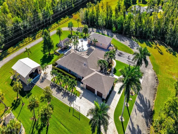 an aerial view of a house with swimming pool and garden