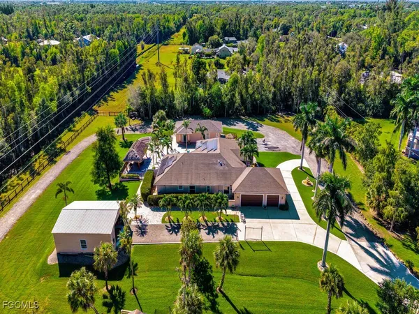 a view of house with garden space and lake view