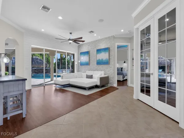 a living room with furniture and large windows