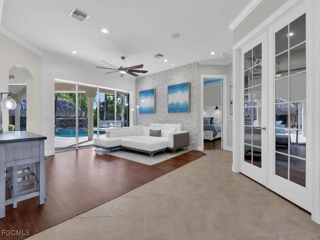 a living room with furniture and large windows