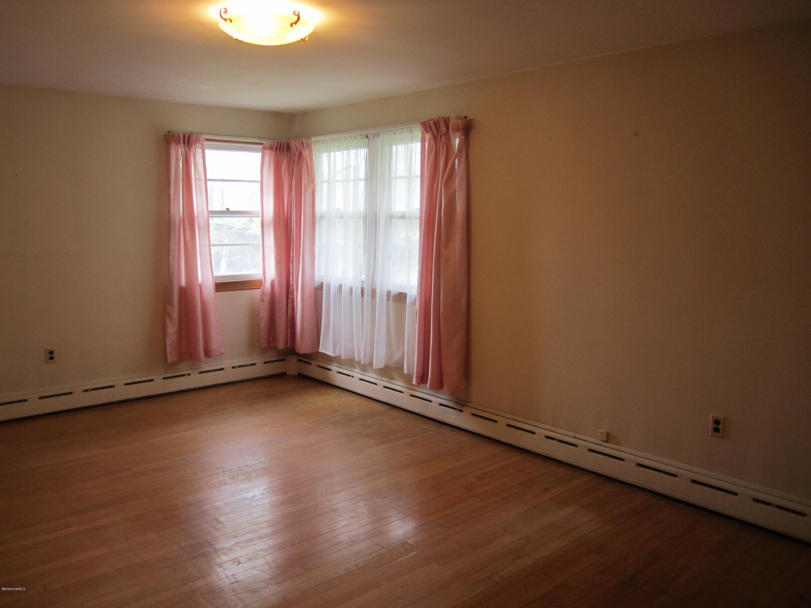 170 East Road Adams, MA 01220 - Photo 17 of 28 an empty room with wooden floor and windows