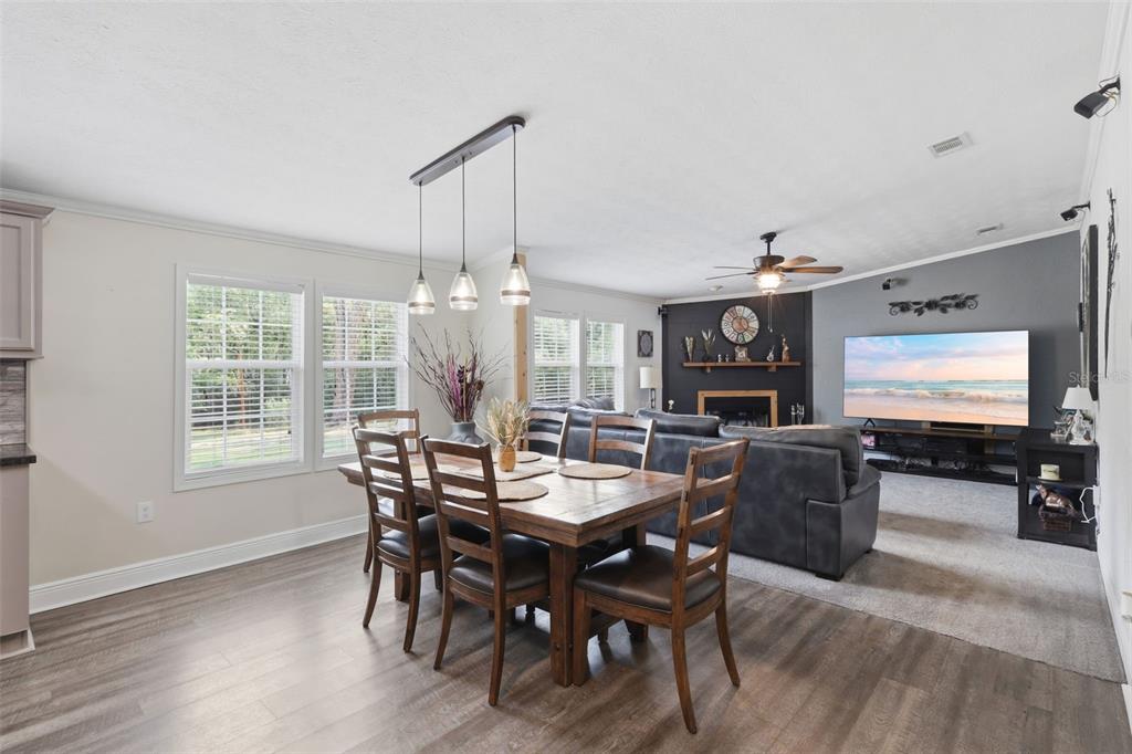 41736 Apollo Lane DeLand, FL 32720 - Photo 14 of 49 a view of a dining room with furniture window and wooden floor