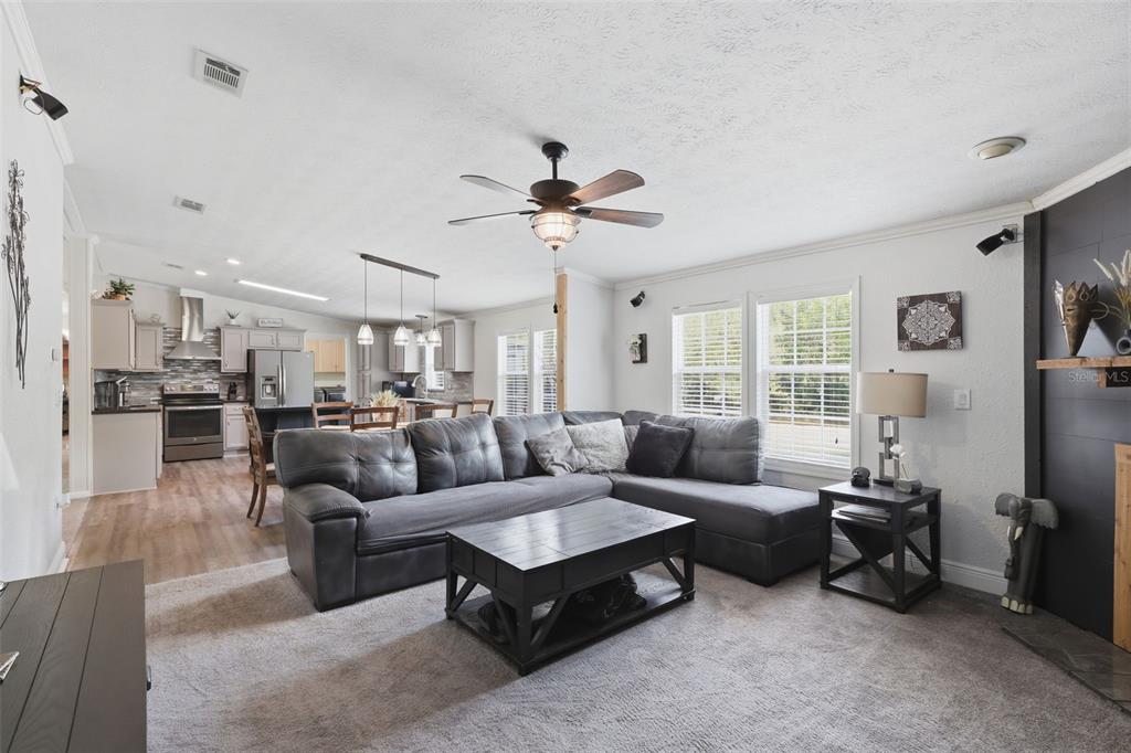 41736 Apollo Lane DeLand, FL 32720 - Photo 17 of 49 a living room with furniture kitchen view and a chandelier