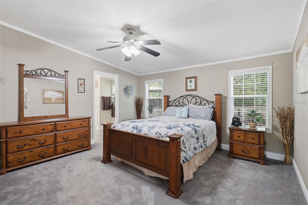41736 Apollo Lane DeLand, FL 32720 - Photo 24 of 49 a bedroom with a bed and a dresser