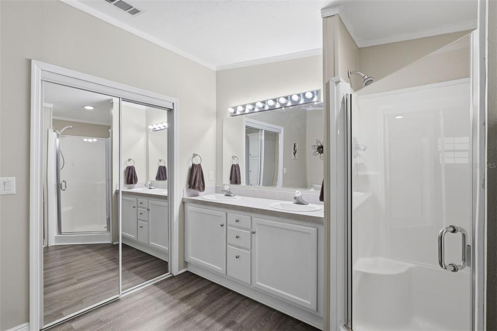 41736 Apollo Lane DeLand, FL 32720 - Photo 26 of 49 a spacious bathroom with a double vanity sink a mirror and shower