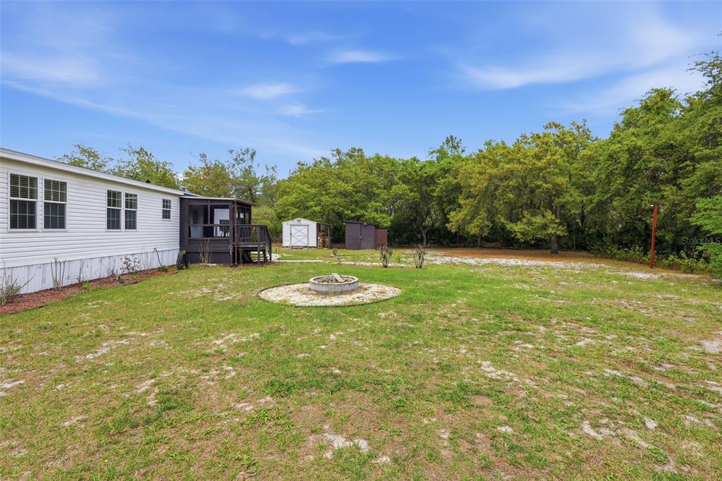 41736 Apollo Lane DeLand, FL 32720 - Photo 39 of 49 a view of a house with a big yard and potted plants