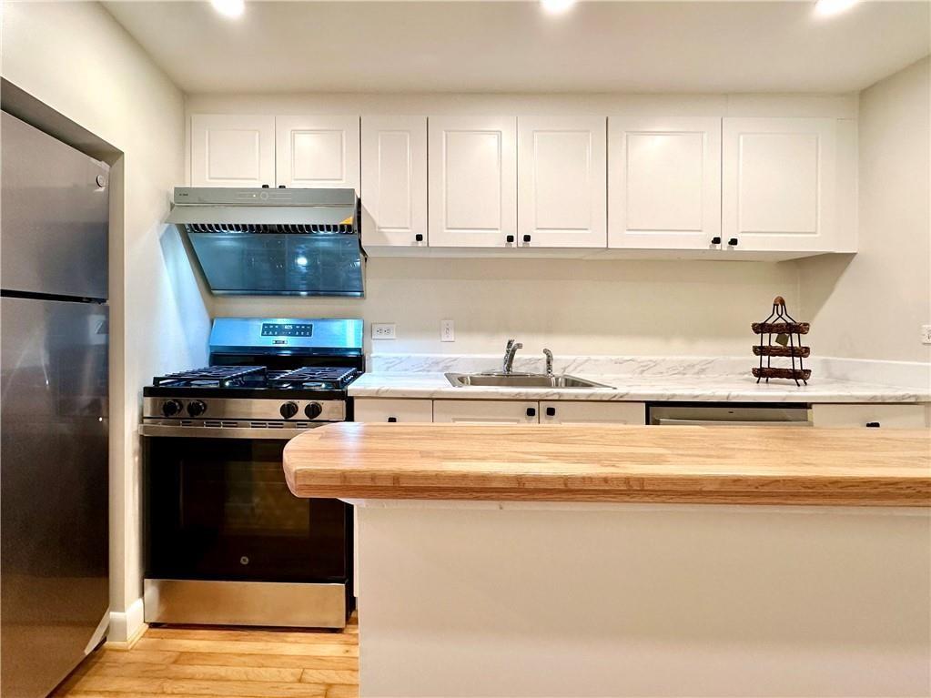 1501 Clairmont Road, Unit 1917 Decatur, GA 30033 - Photo 9 of 10 a kitchen with stainless steel appliances granite countertop a sink stove and refrigerator
