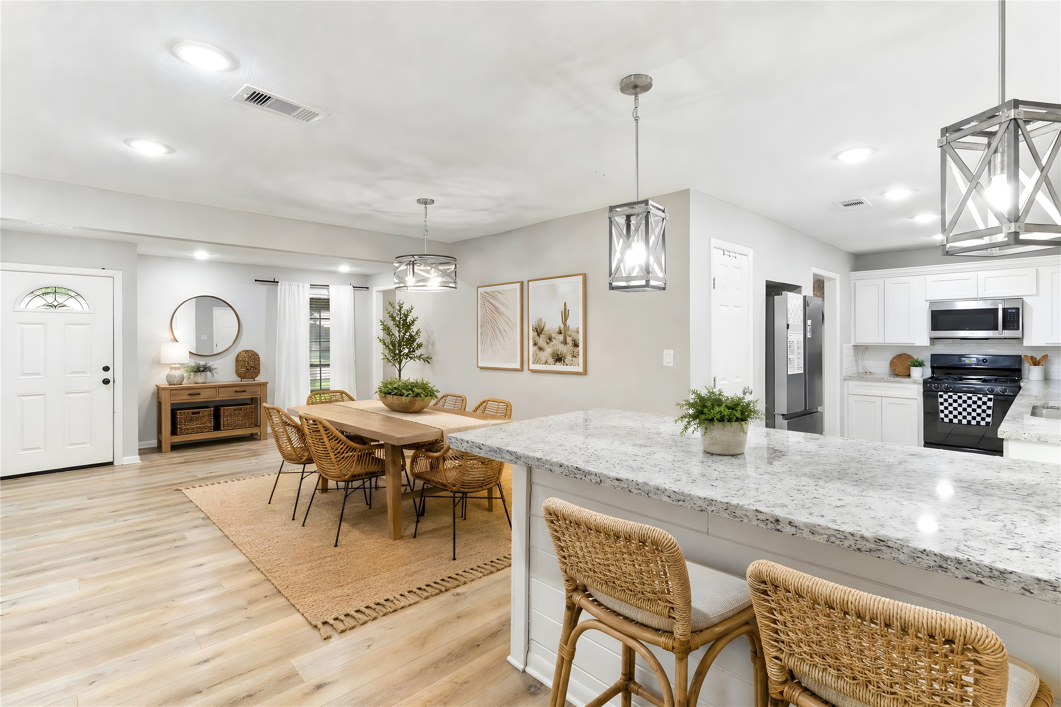 117 Cannon Street Clute, TX 77531 - Photo 8 of 24 The granite island opens to the dining area, creating an easy flow with pendant lighting.