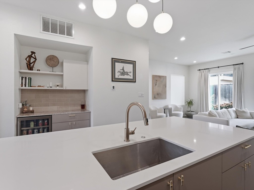 4606 Fisk Street, Unit B Houston, TX 77009 - Photo 12 of 38 a kitchen with a sink and a stove top oven with wooden floor