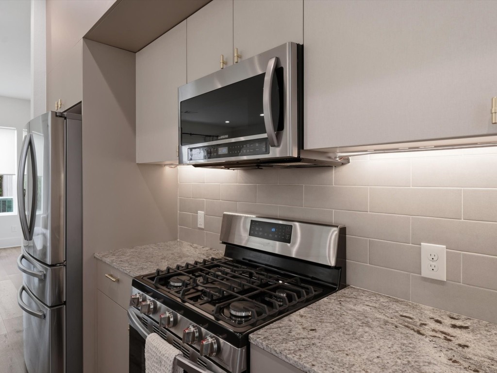 4606 Fisk Street, Unit B Houston, TX 77009 - Photo 13 of 38 a kitchen with a stove and a microwave