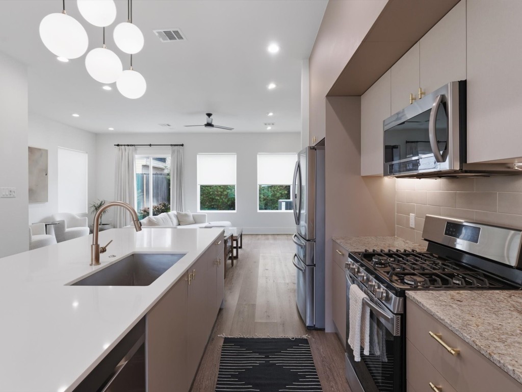 4606 Fisk Street, Unit B Houston, TX 77009 - Photo 14 of 38 a kitchen with a sink stainless steel appliances a counter space and cabinets