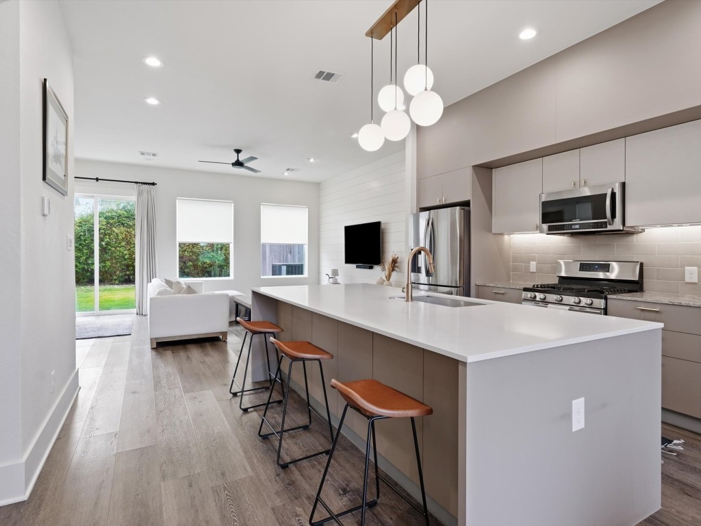 4606 Fisk Street, Unit B Houston, TX 77009 - Photo 2 of 38 a kitchen with stainless steel appliances a sink stove and refrigerator