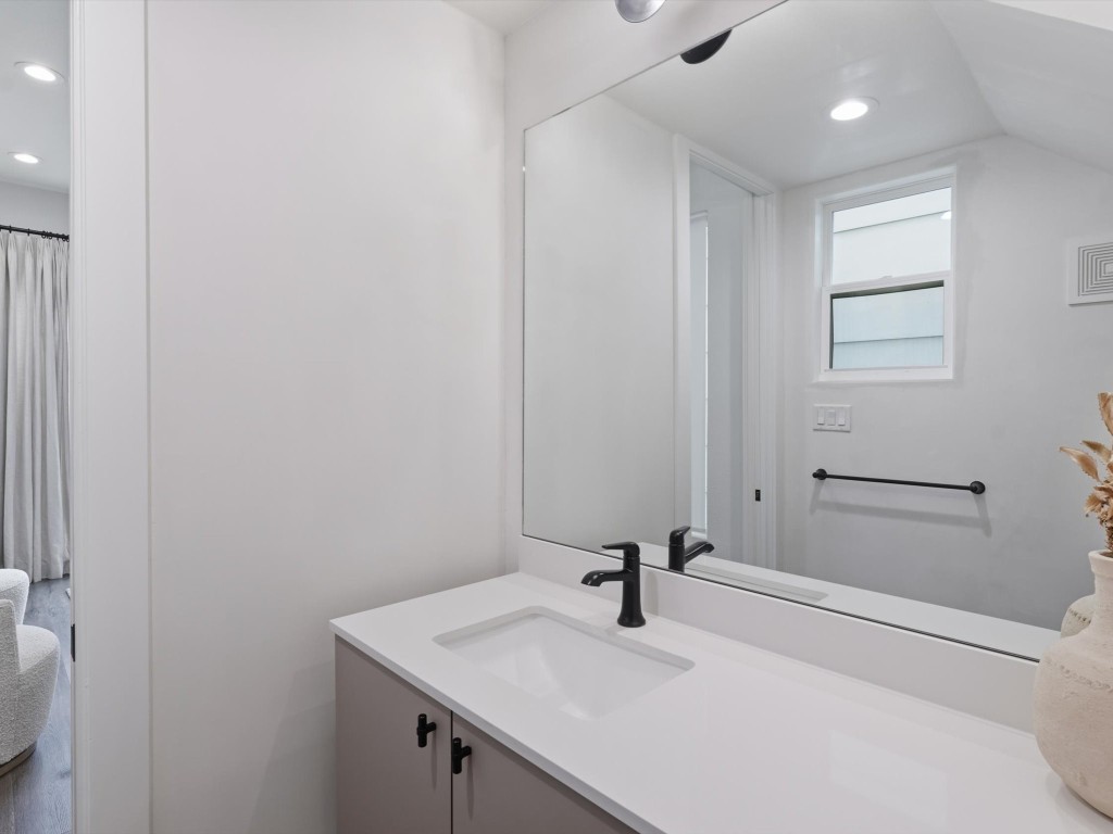 4606 Fisk Street, Unit B Houston, TX 77009 - Photo 23 of 38 a bathroom with a sink a toilet and a mirror