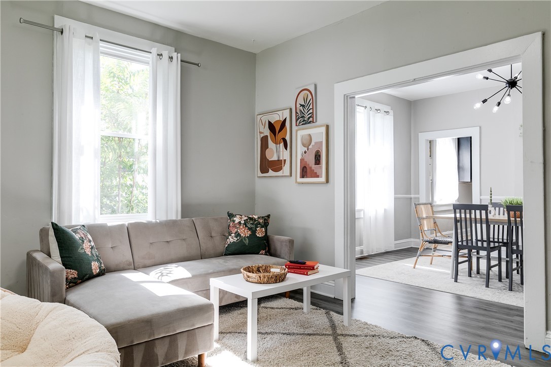 a living room with furniture and wooden floor