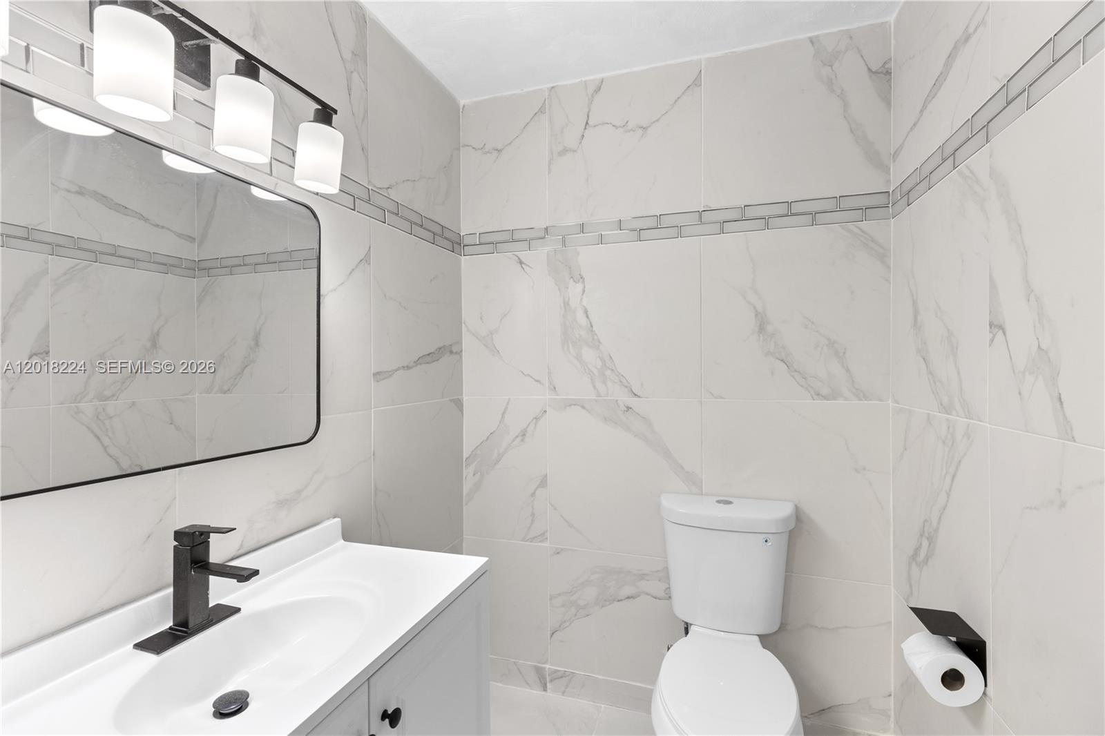 7958 Southwest 6th Street Pompano Beach, FL 33068 - Photo 35 of 57 a bathroom with a toilet sink and shower curtain
