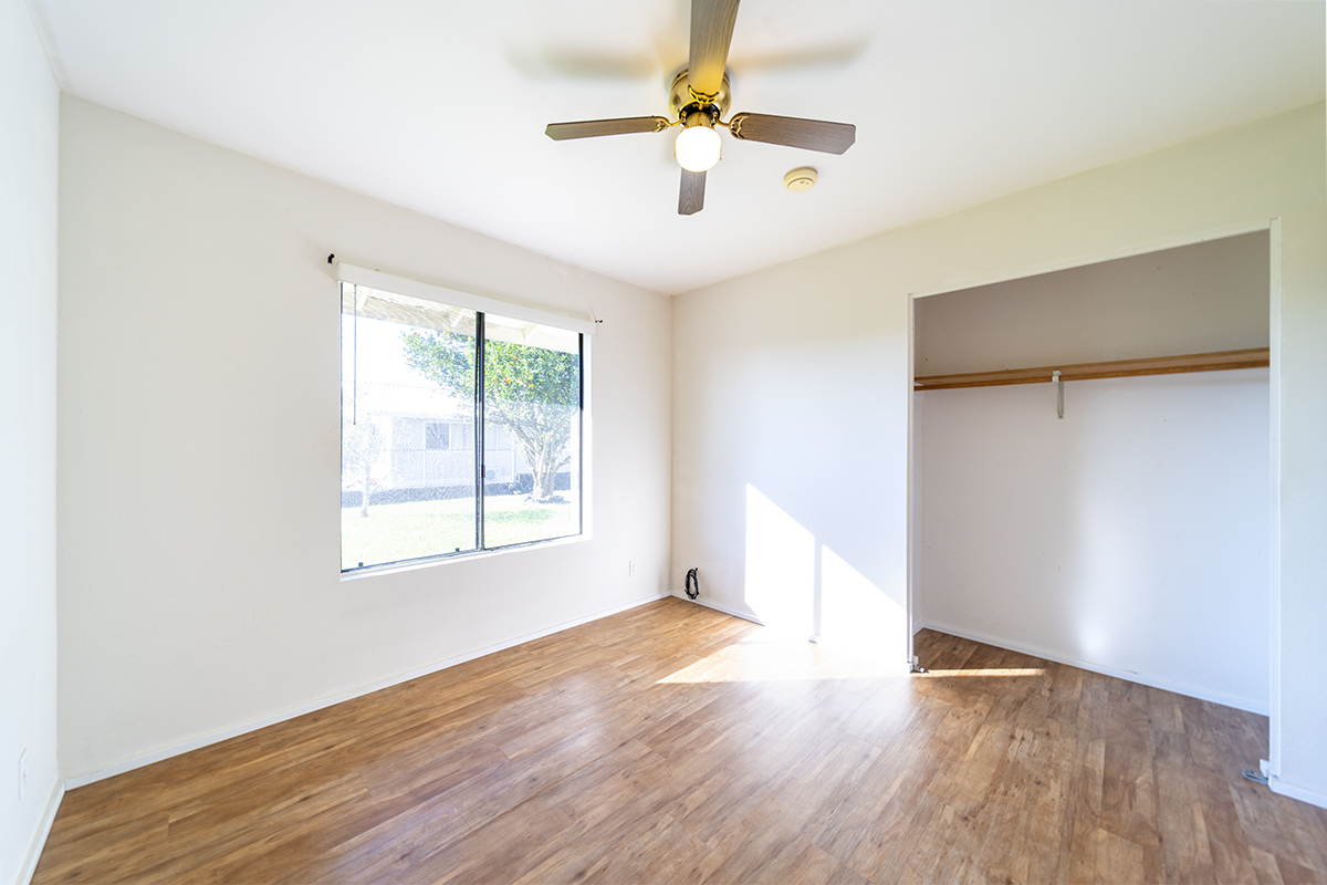 20 Naniakea Street Hilo, HI 96720 - Photo 11 of 29 wooden floor in an empty room with a window