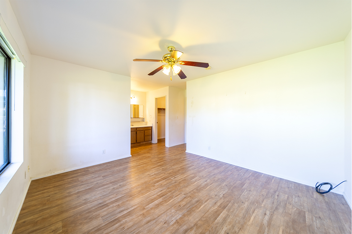 20 Naniakea Street Hilo, HI 96720 - Photo 14 of 29 a view of a room with wooden floor and a ceiling fan