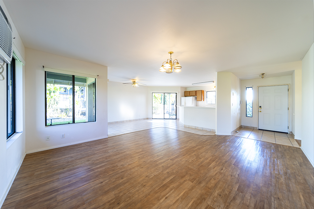 20 Naniakea Street Hilo, HI 96720 - Photo 3 of 29 an empty room with wooden floor and windows