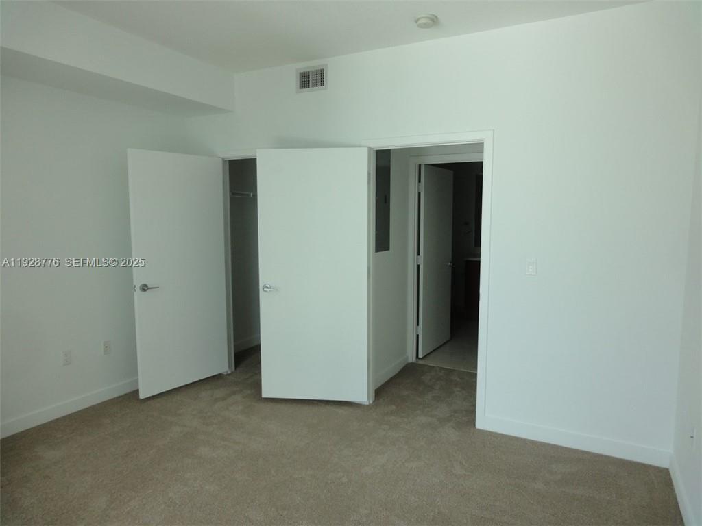 79 Southwest 12th Street, Unit 1203S Miami, FL 33130 - Photo 11 of 21 an empty room with closet
