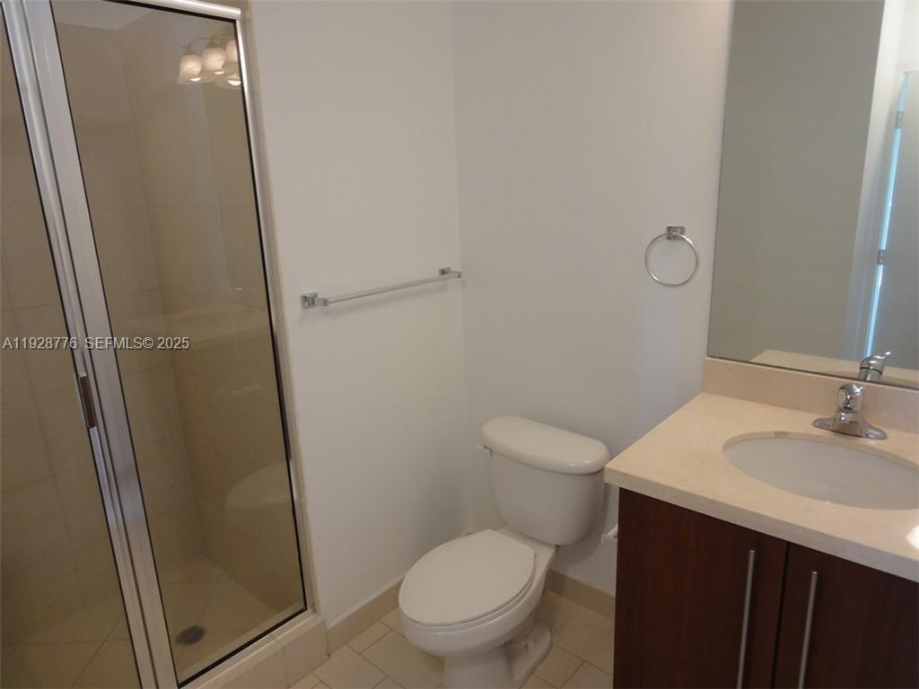 79 Southwest 12th Street, Unit 1203S Miami, FL 33130 - Photo 13 of 21 a white toilet sitting next to a bathroom sink