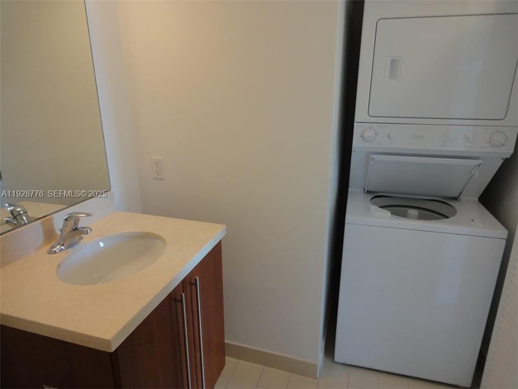79 Southwest 12th Street, Unit 1203S Miami, FL 33130 - Photo 14 of 21 a bathroom with a sink and mirror