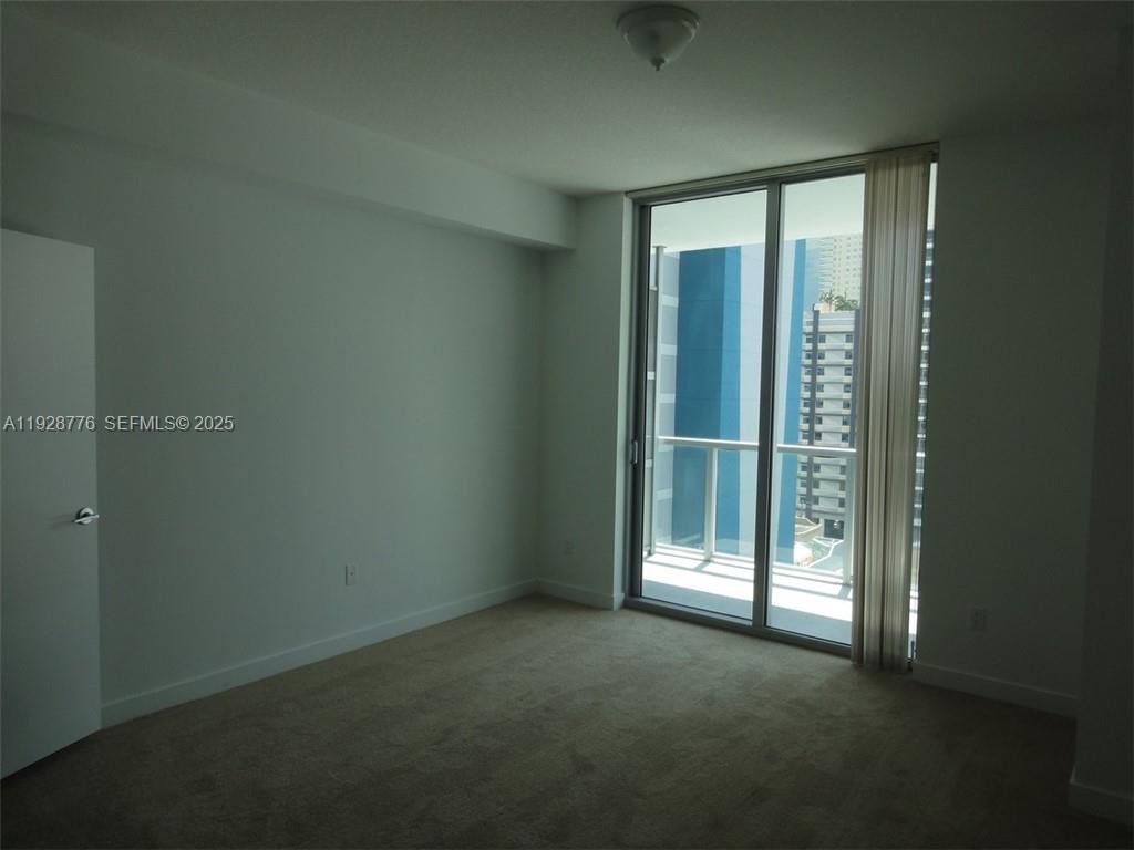 79 Southwest 12th Street, Unit 1203S Miami, FL 33130 - Photo 7 of 21 an empty room with windows