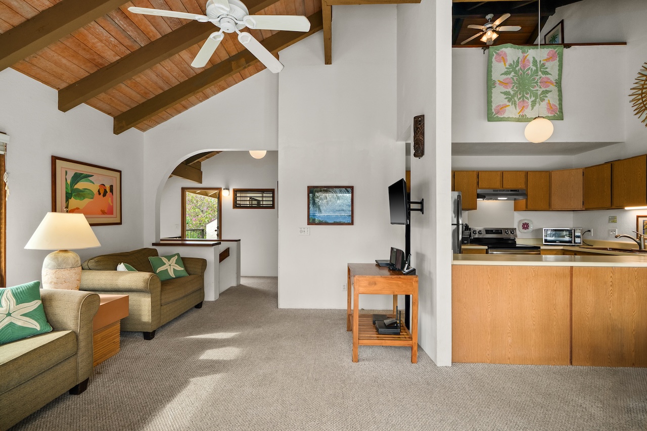 1901 Poipu Road, Unit 421 Koloa, HI 96756 - Photo 5 of 26 a living room with furniture a chandelier and a dining table