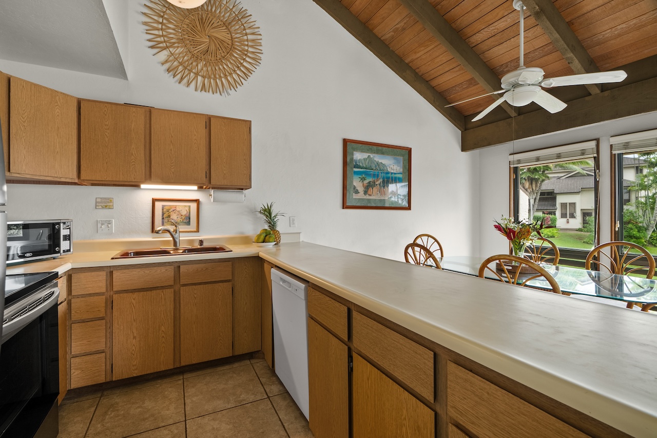 1901 Poipu Road, Unit 421 Koloa, HI 96756 - Photo 6 of 26 a kitchen with a sink cabinets and window