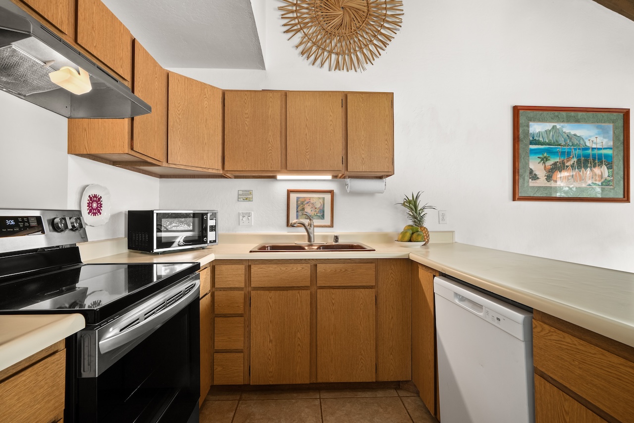 1901 Poipu Road, Unit 421 Koloa, HI 96756 - Photo 8 of 26 a kitchen with a sink cabinets and stainless steel appliances