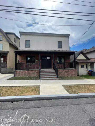 a view of a living room and entryway