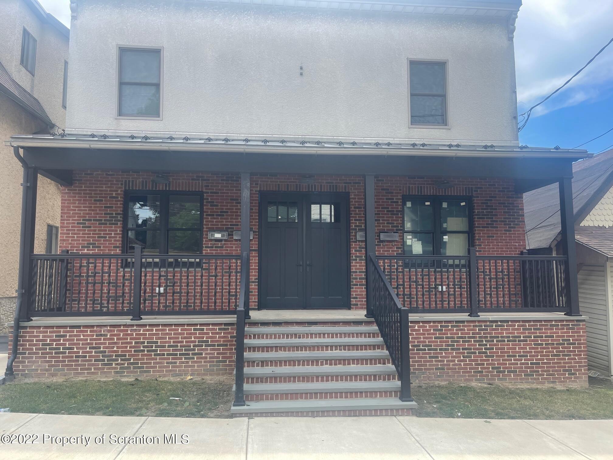 436 Larch Street, Unit 2 Scranton, PA 18509 - Photo 2 of 11 a view of a brick house with large windows