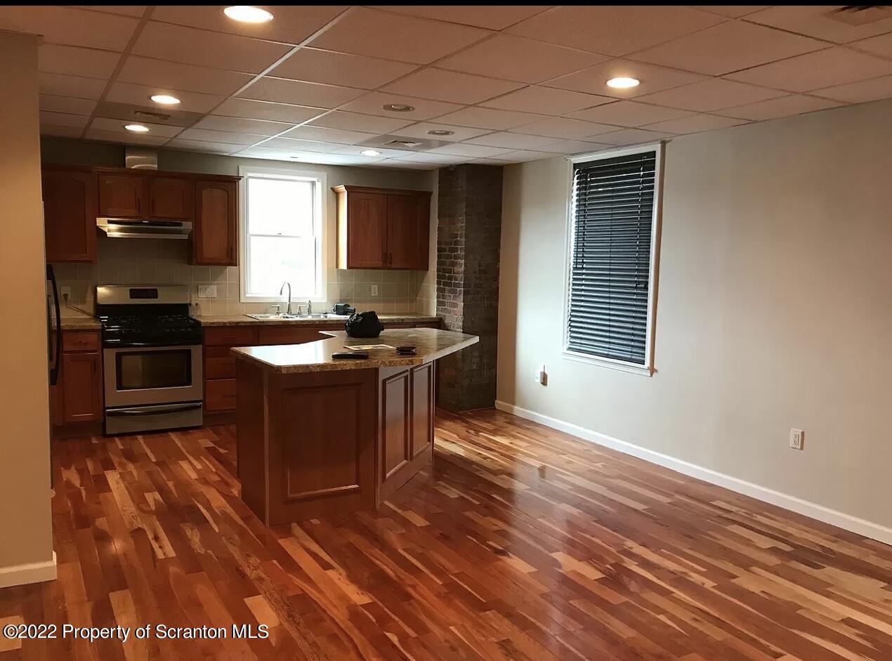 436 Larch Street, Unit 2 Scranton, PA 18509 - Photo 6 of 11 a kitchen with stainless steel appliances granite countertop a stove a sink and a refrigerator