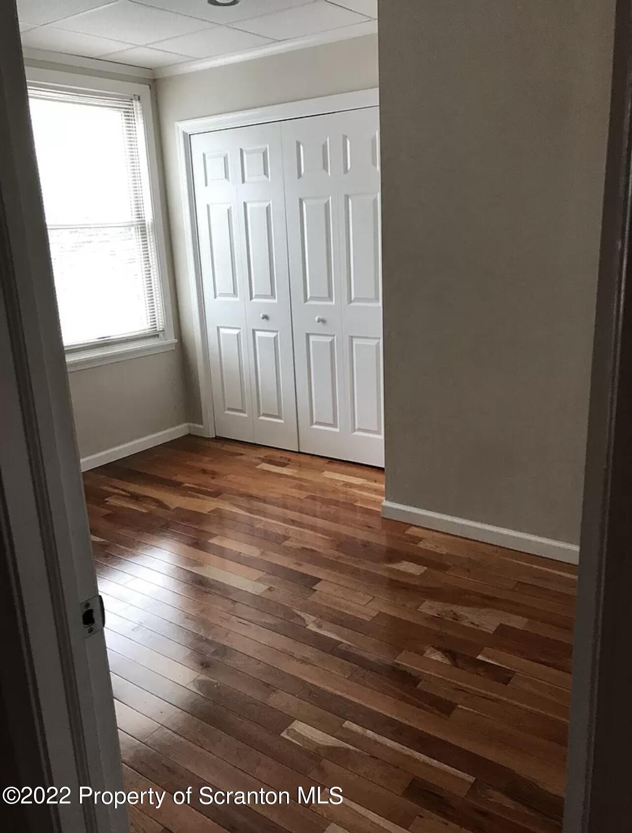 436 Larch Street, Unit 2 Scranton, PA 18509 - Photo 8 of 11 an empty room with wooden floor