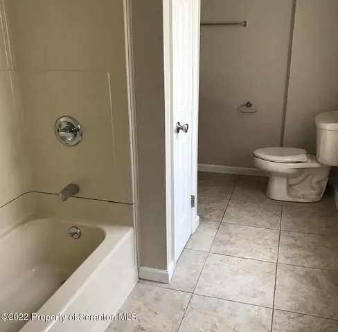a bathroom with a bathtub and toilet