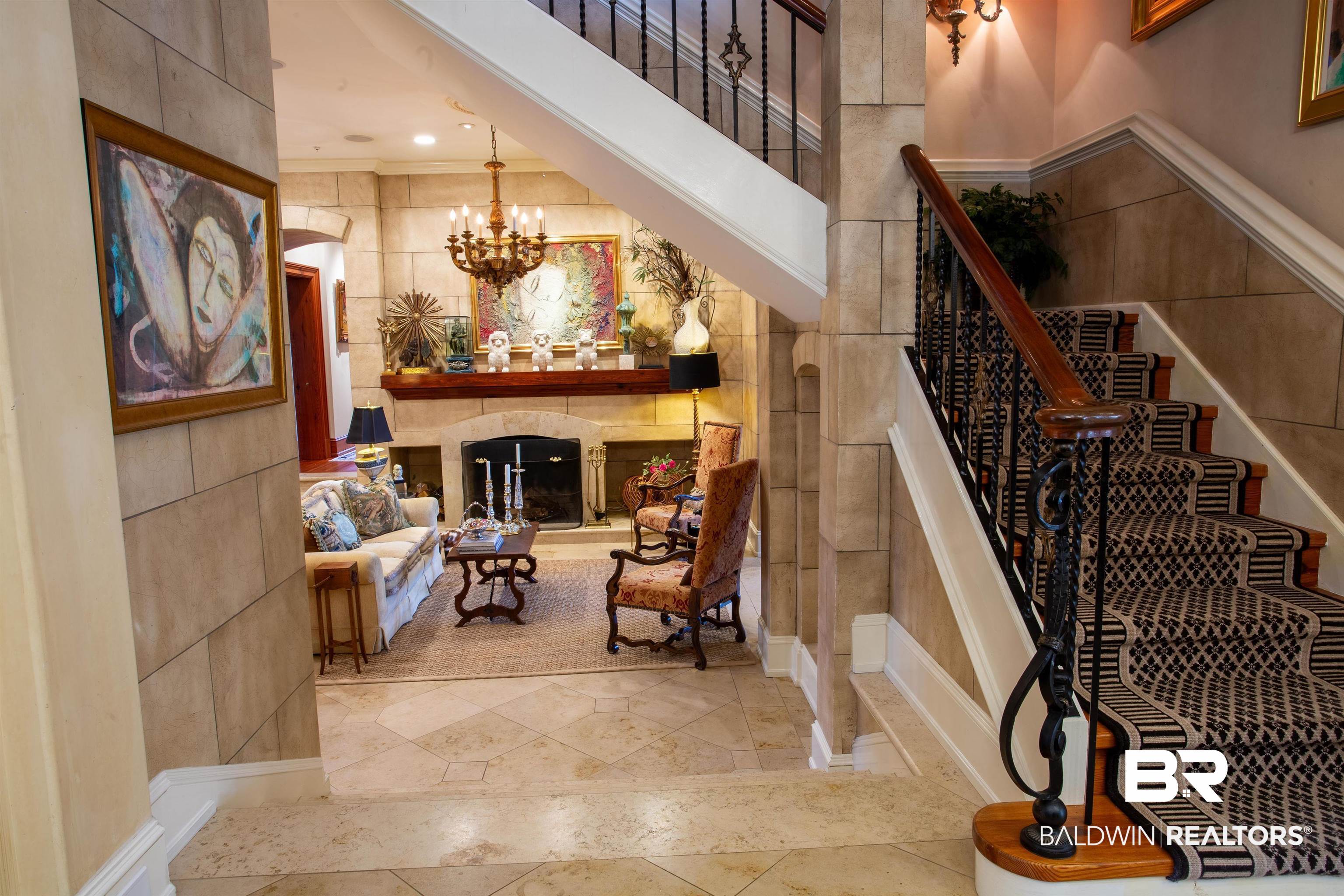 150 Austill Avenue Mobile, AL 36608 - Photo 20 of 39 Grand entryway featuring a curved staircase with wrought iron balusters and a dark wood handrail