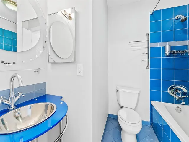 a bathroom with a sink mirror bathtub and toilet